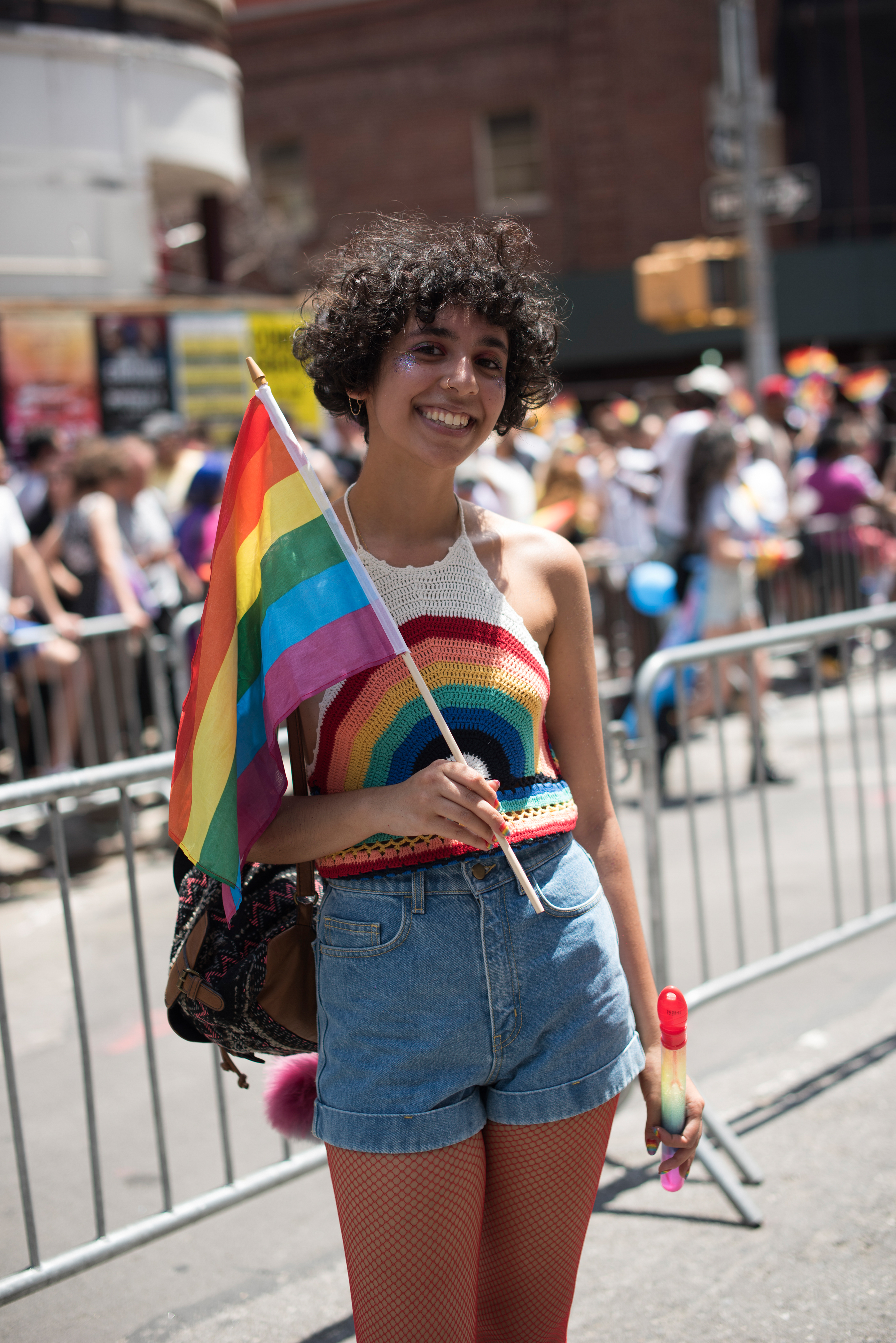 Individual at at Pride Event holding LGBTQ Flag