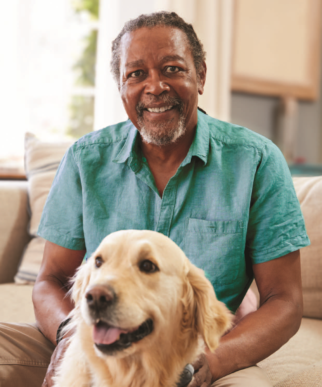 Photo: man and dog sitting on couch